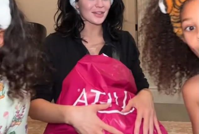 Speculation that Kylie Jenner might be pregnant with her third child has gone into overdrive after she appeared to cover her stomach in a video (seen)