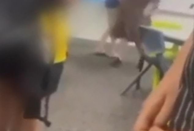 Shocked students watched on as a parent threatened a young girl in a classroom at St Paul's College in Adelaide on Monday