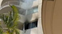 A woman has died after fire engulfed a third storey unit at the  Surf Parade Resort