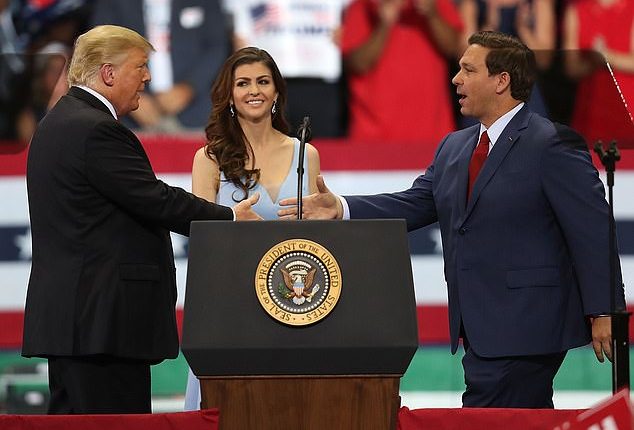 Trump greets Ron DeSantis and his wife Casey at a campaign rally at the Hertz Arena on October 31, 2018 in Estero, Florida