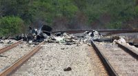 The smoldering wreckage of a Cessna plane is seen after a crash in Boca Raton, Florida, on Friday that killed all three people on board