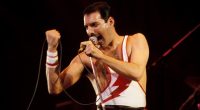 Freddie Mercury performing on stage.