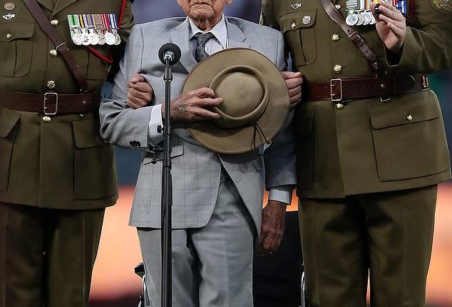 Arthur Leggett (centre) at Optus Stadium in 2022, where he delivered the Ode of Remembrance