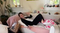 Selena Gomez poses as she signs autographs in living room but fans are distracted by ‘raunchy’ item in the background