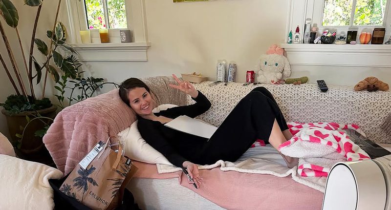 Selena Gomez poses as she signs autographs in living room but fans are distracted by ‘raunchy’ item in the background