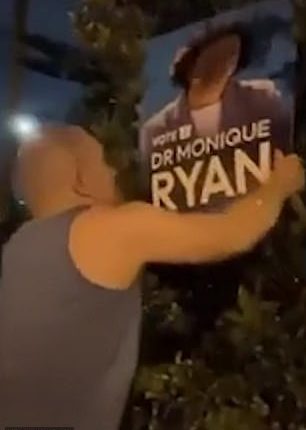 In the first shot, Professor Malham can be seen pulling down the campaign board of Dr Monique Ryan