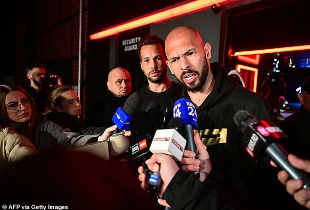 Andrew Tate (R) and his brother Tristan (2R) speak to the media as they arrive in Romania back from US, in Bucharest March 22, 2025