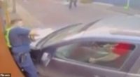 New CCTV footage shows a policeman being pinned to a wall by a car (pictured) during the arrest of an allegedly armed man