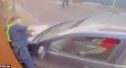 New CCTV footage shows a policeman being pinned to a wall by a car (pictured) during the arrest of an allegedly armed man