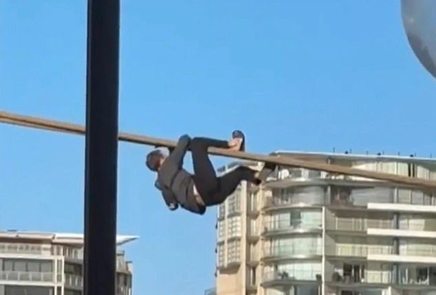 A man seen climbing the mooring lines of a cruise ship on Sydney Harbour has been arrested