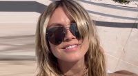 Heidi Klum nearly busts out of pink bikini as husband Tom Kaulitz rubs sunblock on her butt during Cannes getaway