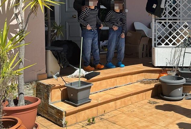 Two of the children are lead from the house in Spain after police intervened on Wednesday