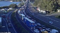 Emergency services are working to free a 'severely trapped' driver after their truck collided with a car on the Hawkesbury River Bridge near Mooney Mooney