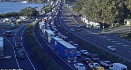 Emergency services are working to free a 'severely trapped' driver after their truck collided with a car on the Hawkesbury River Bridge near Mooney Mooney