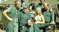 Loretta Swit pictured above surrounded by her  M*A*S*H* cast members, from left: Mike Farrell, William Christopher, Harry Morgan, Alan Alda, Jamie Farr, and David Ogden Stiers
