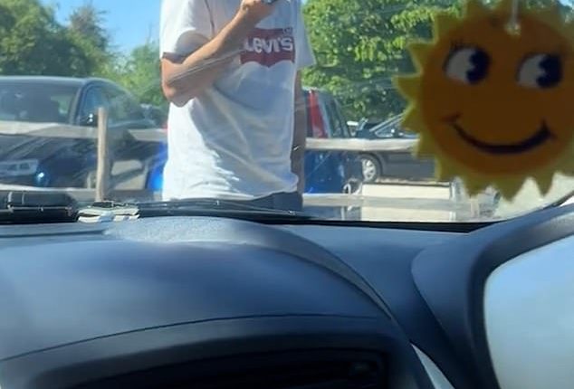 This is the astonishing moment a pedestrian refused to move in a three-minute car park standoff with a driver as he tried to reserve a parking space for his family