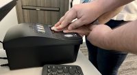 A Flagler County Sheriff’s Office Public Service Officer at the Flagler Sheriff’s Operations Center scans fingerprints for a background check. (FCSO)