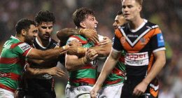 Two men have been arrested over an alleged wild brawl during Sunday night's clash between the Tigers and Rabbitohs at Campbelltown Sports Stadium (pictured, Souths celebrate a try during the game)