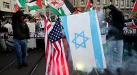 Pro-Palestine protesters in Basel burn Israeli flag as act who survived terror attack performs in Eurovision