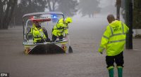 epaselect epa12124624 NSW Fire Rescue personnel assist an elderly resident during flooding in Port Macquarie, New South Wales, Australia, 22 May 2025. A slow-moving trough is dumping rain along the east coast of Australia, leaving thousands of people stranded.  EPA/Lindsay Moller AUSTRALIA AND NEW ZEALAND OUT