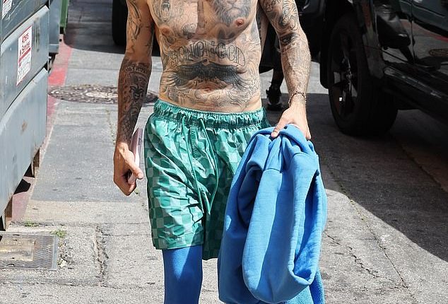Justin Bieber left fans scratching their heads when he bizarrely stepped out in Los Angeles on Thursday while shirtless in Beverly Hills
