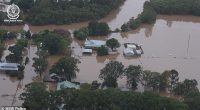 Supermarket shelves are empty as record floodwaters and heavy rains cut off sections of the Pacific and left three dead. Pictured is an aerial shot of the town of Taree underwater