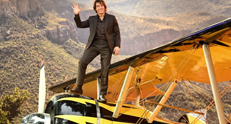 Tom Cruise, 62, climbs onto the nose of a plane as he joins glam stars at Mission Impossible premiere in London