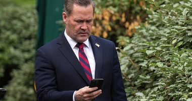 National Security Adviser Michael Waltz looks at his phone as he prepares for a TV interview at the White House on Thursday immediately before his firing