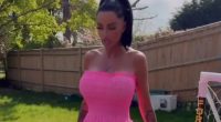 Watch moment Katie Price shoves aside cat with her FOOT as she models Barbie pink dress in her garden