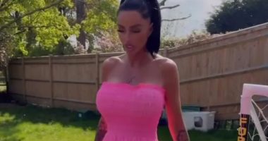 Watch moment Katie Price shoves aside cat with her FOOT as she models Barbie pink dress in her garden
