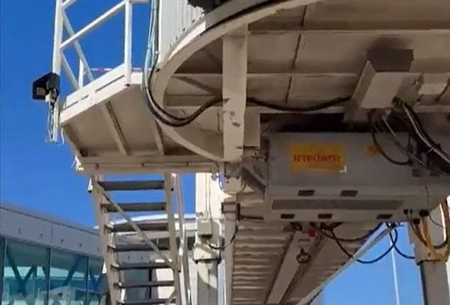 Pictured is the gaping hole in an aerobridge a Qantas worker is believed to have fallen through