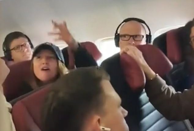 A Perth woman (above, gesturing at a stewardess) travelling from Western Australia to Melbourne was hauled off a plane before departure after a bizarre altercation with cabin crew