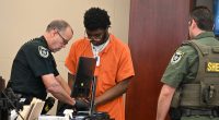 Brendan Depa getting finger-printed after his sentencing hearing on Aug. 6, 2024. (© FlaglerLive)