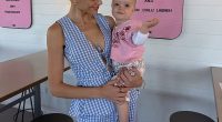 Em Davies (pictured with Isla Sue) was stranded in an airport for four hours while travelling on her own with her nine-month-old baby for the first time