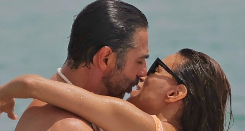 Eva Longoria rocks cheeky orange swimsuit as she packs on PDA with husband Jose Baston on beach in Spain