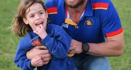 Four-year-old Marigold Jessie has been rushed home to Australia after a fall from a Balinese tree house caused a brain bleed (pictured in her local football club's colours)