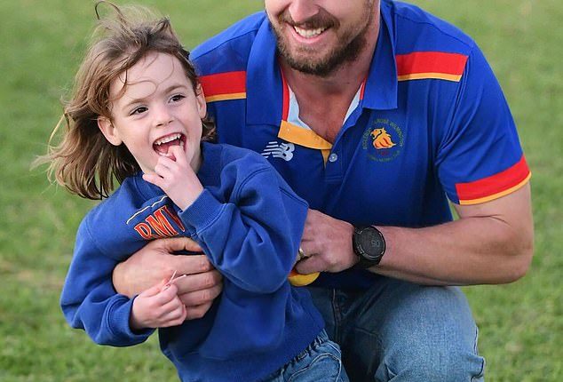 Four-year-old Marigold Jessie has been rushed home to Australia after a fall from a Balinese tree house caused a brain bleed (pictured in her local football club's colours)