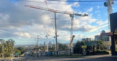 Pennant Hills Road is empty as crews assess a crane that could fall due to high winds