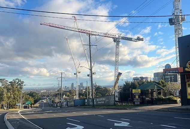 Pennant Hills Road is empty as crews assess a crane that could fall due to high winds