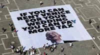 Amazon boss Jeff Bezos and bride to be Lauren Sanchez 's have been forced to change one of the venues for their $48 million Venice wedding because of 'rising global tensions' it was claimed today. Pictured: A large banner against Amazon founder Jeff Bezos lies on the ground