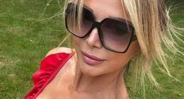 Lizzie Cundy looks stunning as she soaks up the sun in plunging red swimsuit