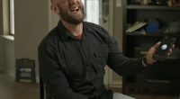 Chris Smith laughs during an interview while speaking with his AI 'companion' Sol - to whom he proposed