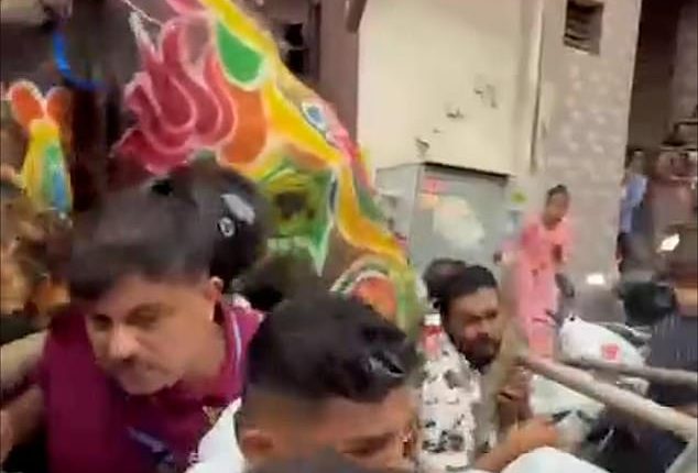This is the horrifying moment a panicked elephant tramples a terrified crowd of festival-goers  in India