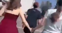 Terror-stricken pupils are seen running down a corridor and a flight of stairs as they are escorted out of the building by heavily armed cops
