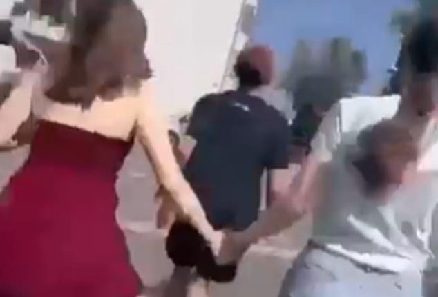 Terror-stricken pupils are seen running down a corridor and a flight of stairs as they are escorted out of the building by heavily armed cops