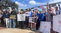 Anti-Trump protesters stand in front of the Florida Historic Capitol on Feb. 5, 2025. (Photo by Jackie Llanos/Florida Phoenix)