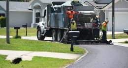 A crew applying an asphalt sealant on a P-Section street in April. The sealant is a lower-grade, cheaper alternative to repaving. It is intended to extend the life of a street