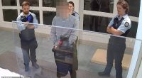 CCTV captured the moment a watch house officer asked an Indigenous teen if he would 'neck himself'