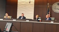 Back in December, Mike Norris would still look occasionally Acting City Manager Lauren Johnston in the eye. (© FlaglerLive)
