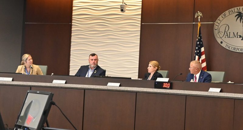 Back in December, Mike Norris would still look occasionally Acting City Manager Lauren Johnston in the eye. (© FlaglerLive)